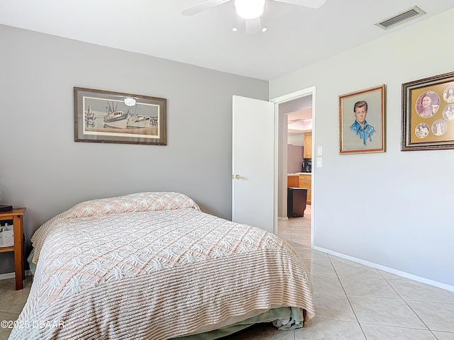 bedroom featuring a ceiling fan, visible vents, baseboards, and light tile patterned floors