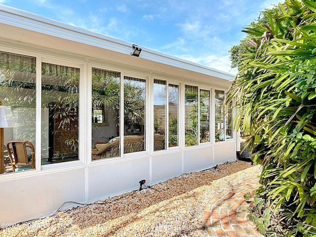 view of home's exterior with a sunroom