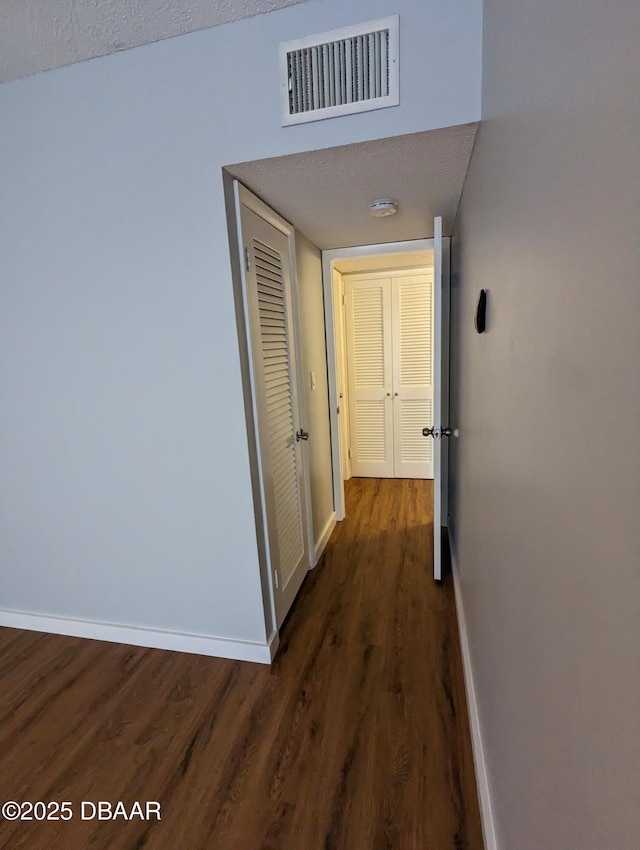 717 S Beach St Unit 102C, Daytona Beach, FL 32114 - hall featuring baseboards and dark wood-style floors