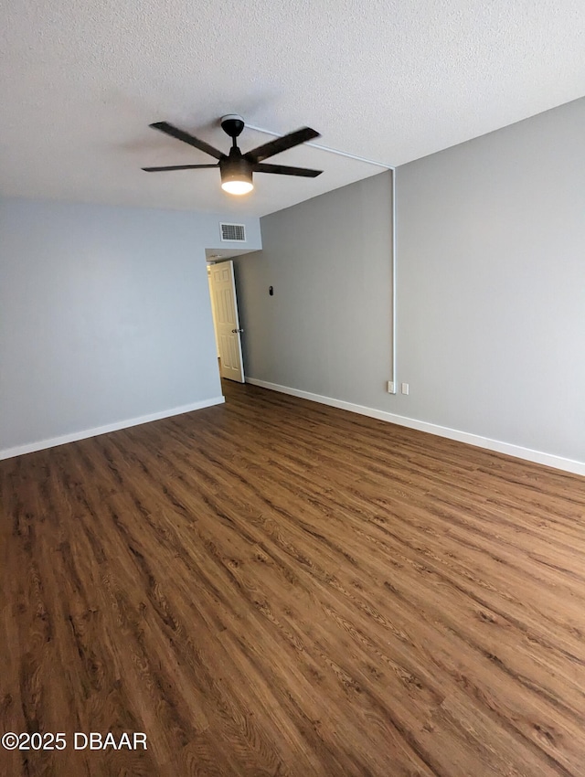 717 S Beach St Unit 102C, Daytona Beach, FL 32114 - unfurnished room with dark wood finished floors, ceiling fan, and a textured ceiling