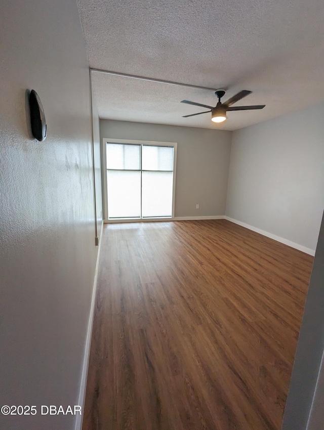 717 S Beach St Unit 102C, Daytona Beach, FL 32114 - empty room featuring wood finished floors, ceiling fan, and a textured ceiling