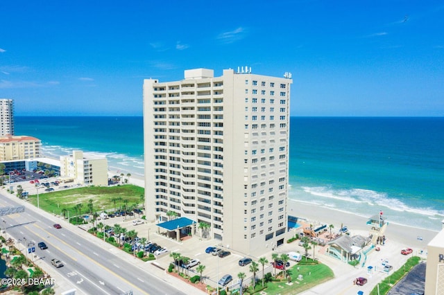 bird's eye view with a water view, a view of city, and a beach view