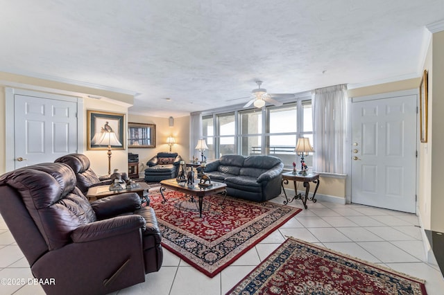 living room with a textured ceiling, light tile patterned flooring, a ceiling fan, and crown molding