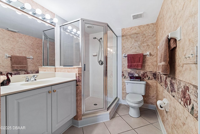 bathroom featuring visible vents, toilet, tile patterned flooring, vanity, and a shower stall