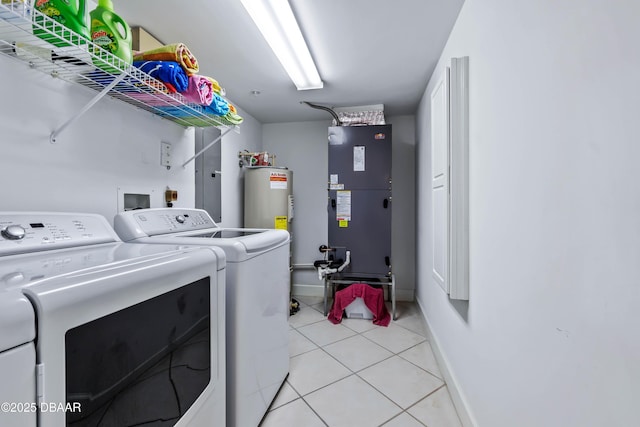 laundry room featuring laundry area, light tile patterned floors, baseboards, independent washer and dryer, and heating unit