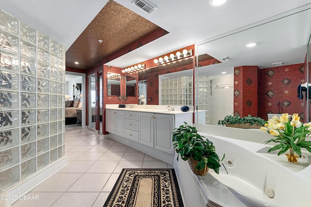 full bath featuring double vanity, visible vents, ensuite bathroom, a sink, and tile patterned flooring