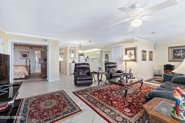 living area with ornamental molding, visible vents, baseboards, and light tile patterned floors