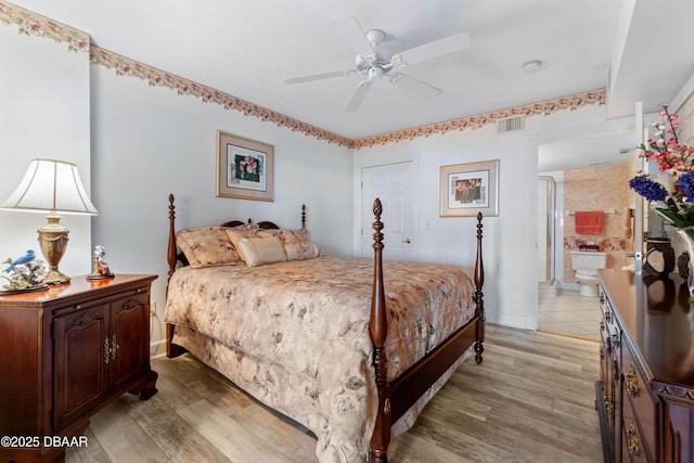 bedroom with visible vents, ensuite bath, light wood-style flooring, and baseboards