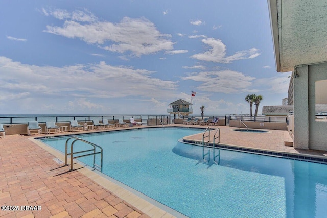 community pool with a water view, a community hot tub, and a patio