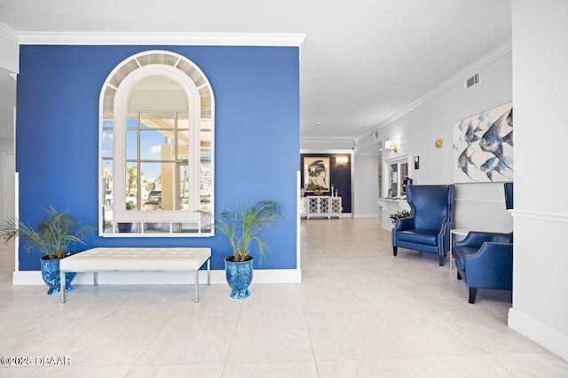 sitting room featuring tile patterned flooring, visible vents, baseboards, and ornamental molding