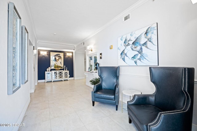 sitting room featuring light tile patterned flooring, crown molding, visible vents, and baseboards