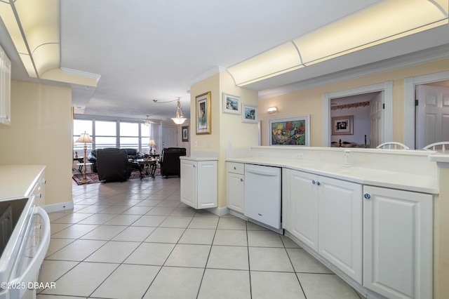 kitchen with dishwasher, light countertops, and decorative light fixtures