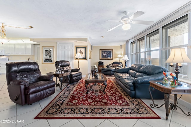 living area featuring ornamental molding, ceiling fan, and light tile patterned floors