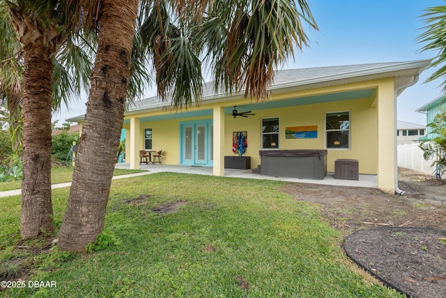 view of front of home featuring a patio, a hot tub, ceiling fan, french doors, and a front yard