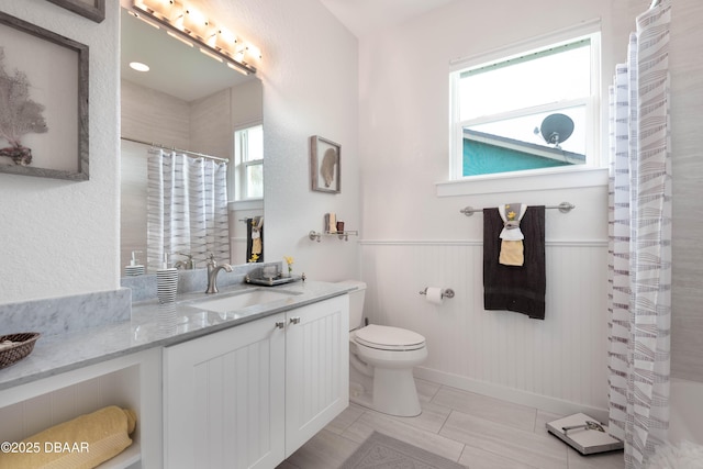 bathroom with toilet, tile patterned flooring, and vanity