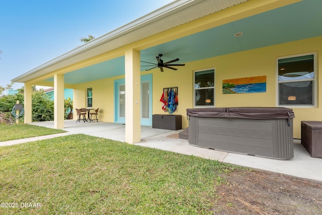 view of patio / terrace featuring ceiling fan and a hot tub