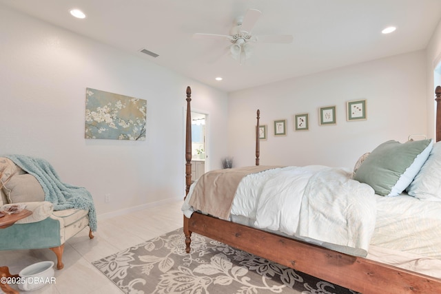 bedroom with ceiling fan, light tile patterned floors, and ensuite bath