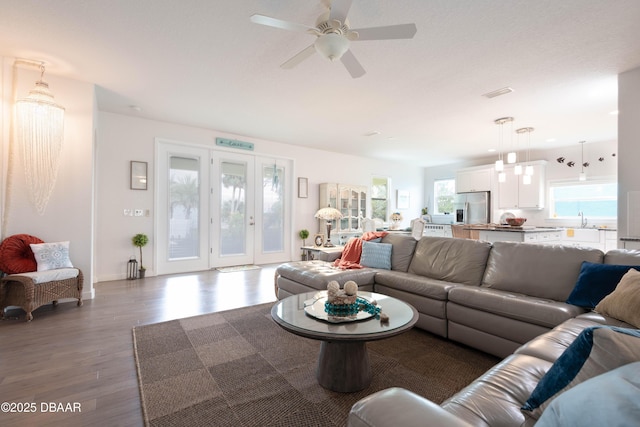 living room with ceiling fan, sink, and dark hardwood / wood-style floors