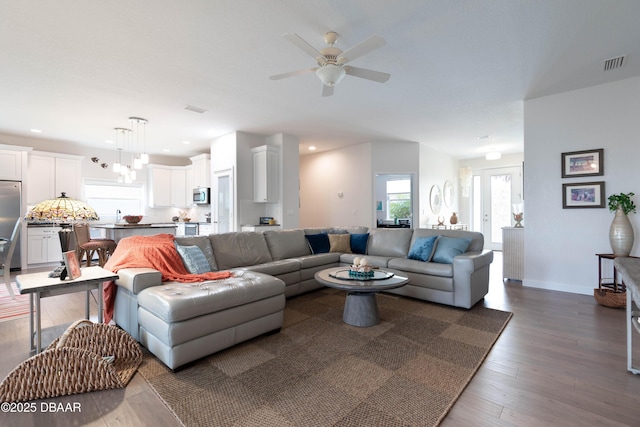 living room featuring dark hardwood / wood-style floors and ceiling fan