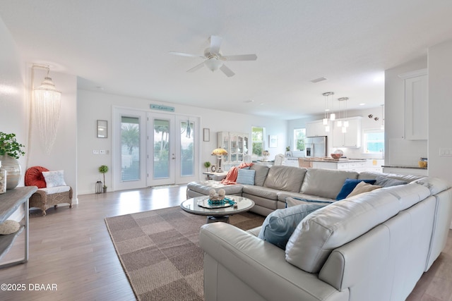 living room featuring ceiling fan and light hardwood / wood-style floors