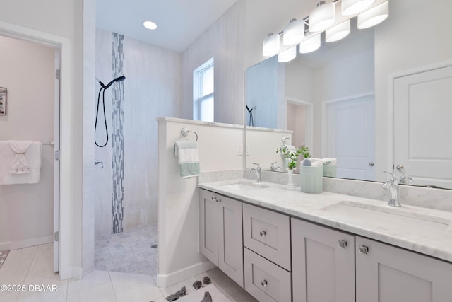 bathroom featuring vanity, tiled shower, and tile patterned floors