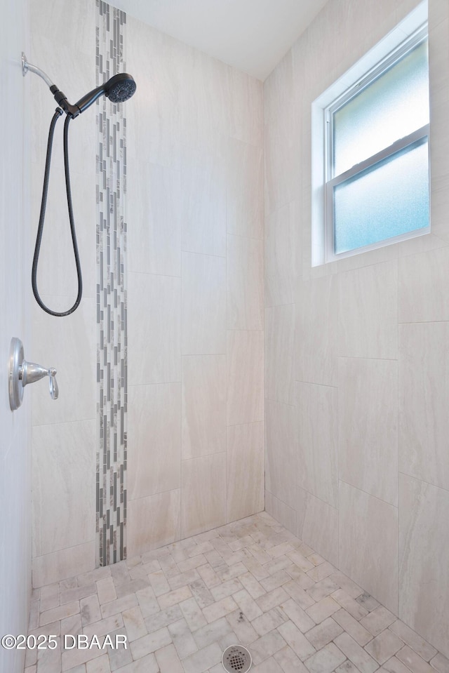 bathroom with a tile shower