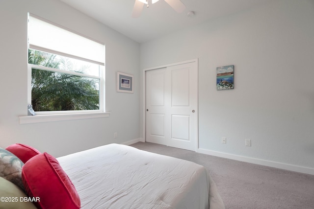 bedroom with a closet, ceiling fan, and carpet flooring