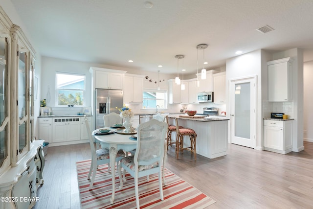 dining room featuring light hardwood / wood-style floors and sink