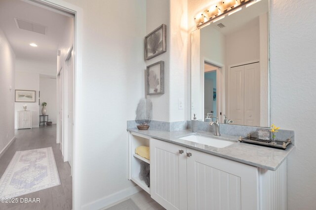 bathroom featuring hardwood / wood-style flooring and vanity