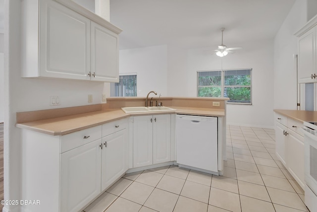 kitchen featuring dishwasher, light tile patterned flooring, white cabinetry, and a sink