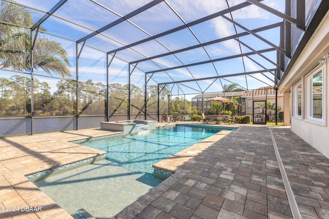 view of swimming pool with glass enclosure and a patio