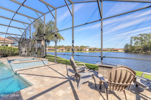 exterior space with pool water feature, glass enclosure, a pool with hot tub, and a water view