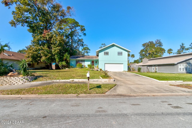 view of front of property with a front lawn and a garage