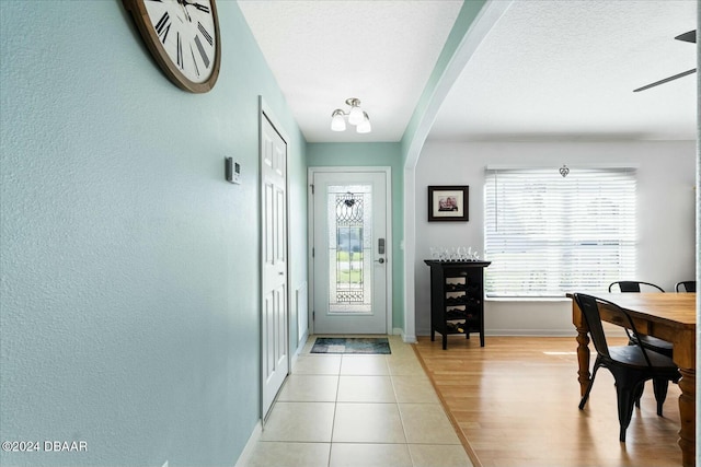 foyer entrance with light hardwood / wood-style flooring and ceiling fan