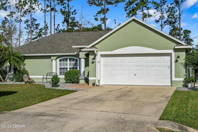 ranch-style home with a garage and a front lawn