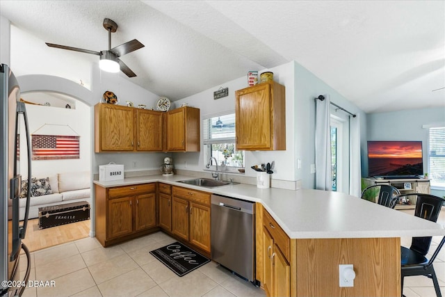 kitchen featuring plenty of natural light, kitchen peninsula, sink, and appliances with stainless steel finishes