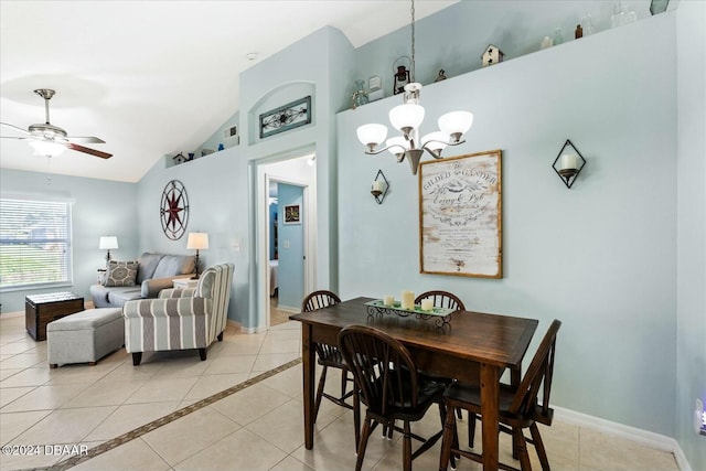 tiled dining room featuring ceiling fan with notable chandelier and lofted ceiling