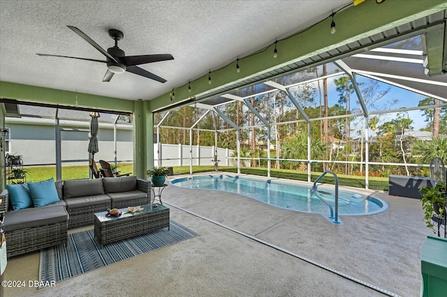 view of pool featuring a lanai, a patio area, an outdoor living space, and ceiling fan