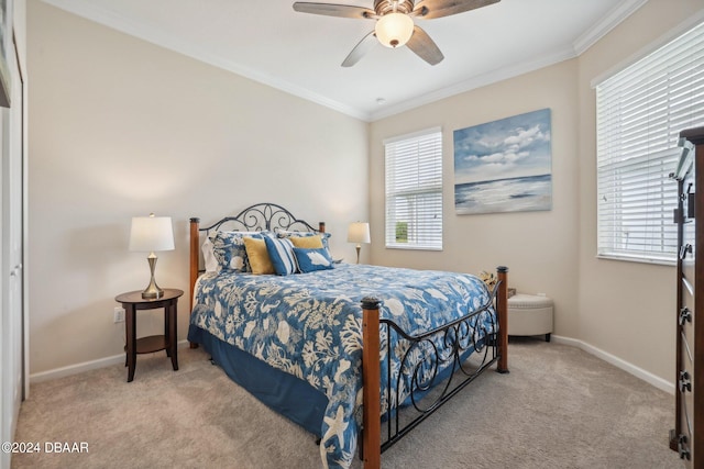 carpeted bedroom featuring ceiling fan, multiple windows, and ornamental molding