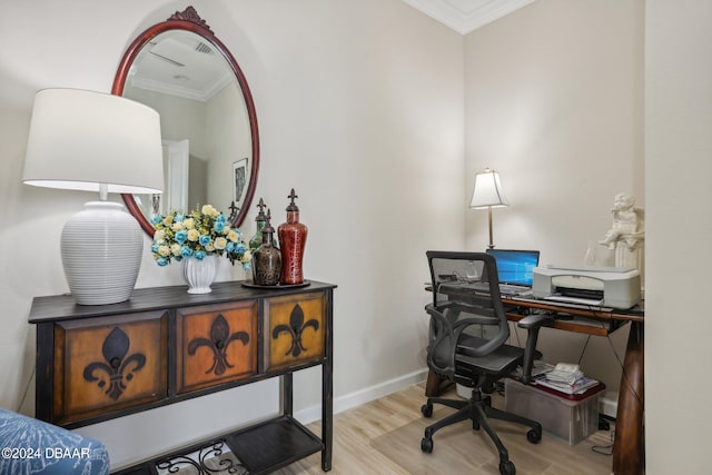 office space with light wood-type flooring and ornamental molding