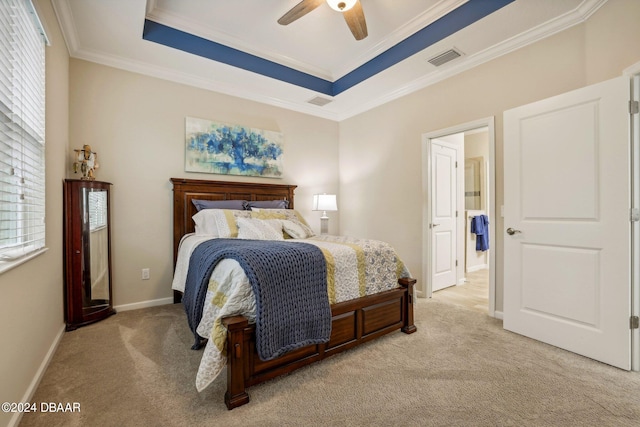 carpeted bedroom featuring a raised ceiling, ceiling fan, and crown molding