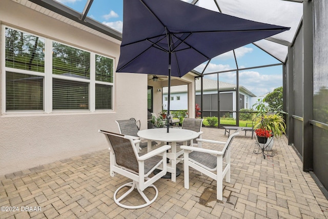 view of patio / terrace with a lanai and ceiling fan