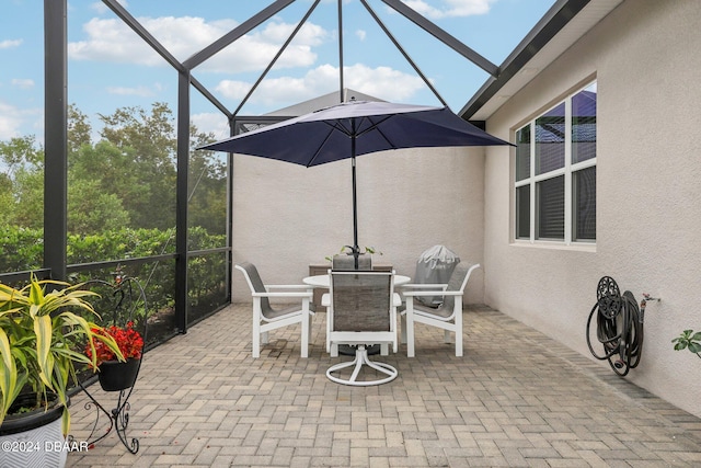 view of patio / terrace featuring glass enclosure