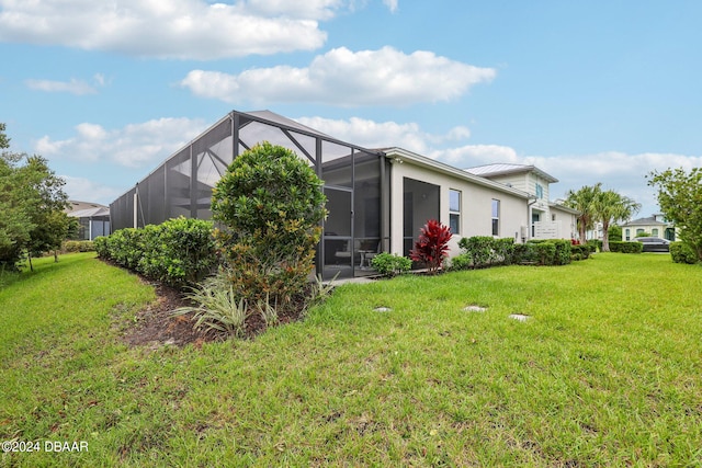 exterior space with a lanai and a yard