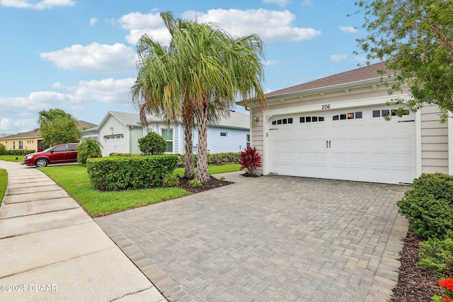 view of front of home featuring a garage and a front yard