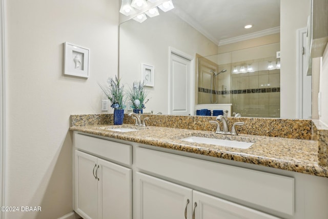 bathroom featuring a shower with door, vanity, and crown molding