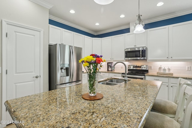 kitchen featuring a center island with sink, sink, ornamental molding, light stone countertops, and appliances with stainless steel finishes