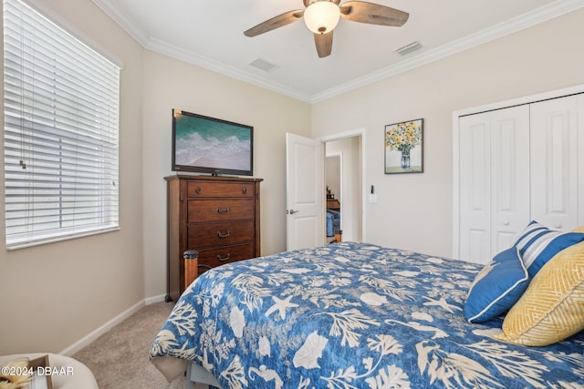 carpeted bedroom featuring ceiling fan, a closet, and ornamental molding