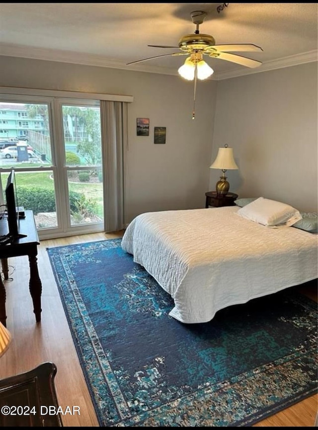 bedroom with ceiling fan, ornamental molding, and hardwood / wood-style flooring