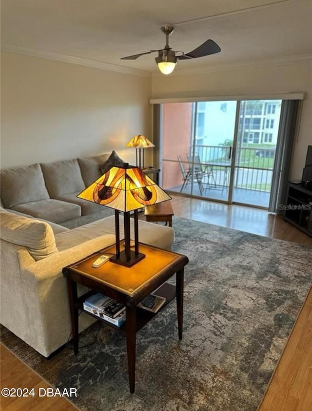 living room featuring dark hardwood / wood-style floors, ceiling fan, and ornamental molding